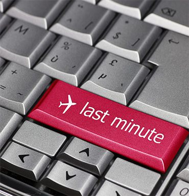 Keyboard key labeled last minute with an airplane icon