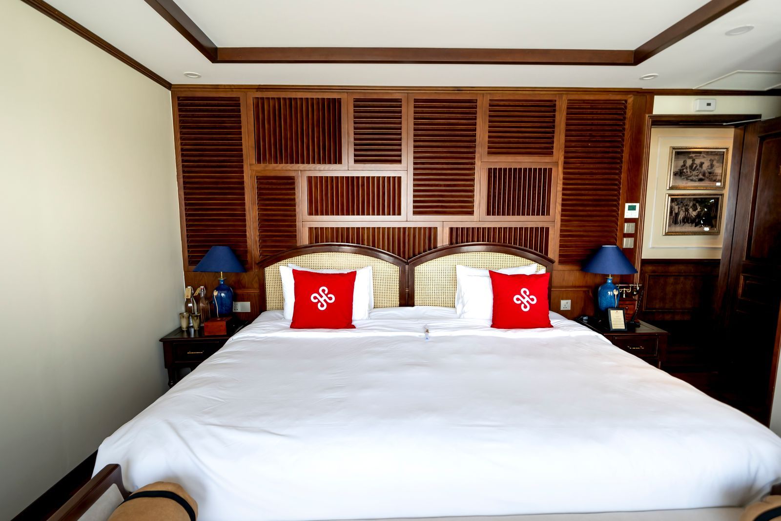 Hotel bedroom with a king bed and wood-paneled headboard
