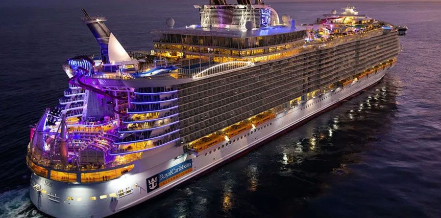 Large cruise ship lit up at dusk