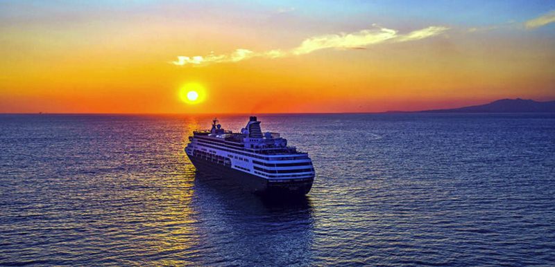 Cruise ship at sea at sunset